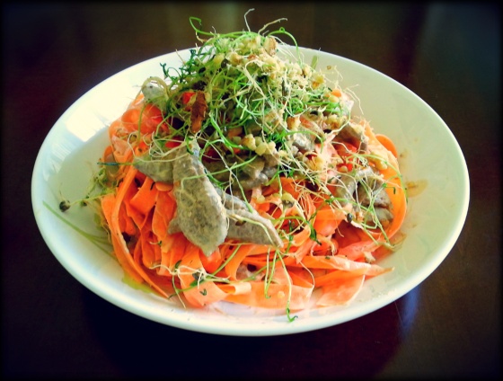 Carrot pasta, soya slices and sprouted black lentils in almonds cream (raw).